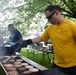 Sailor cooks during base event