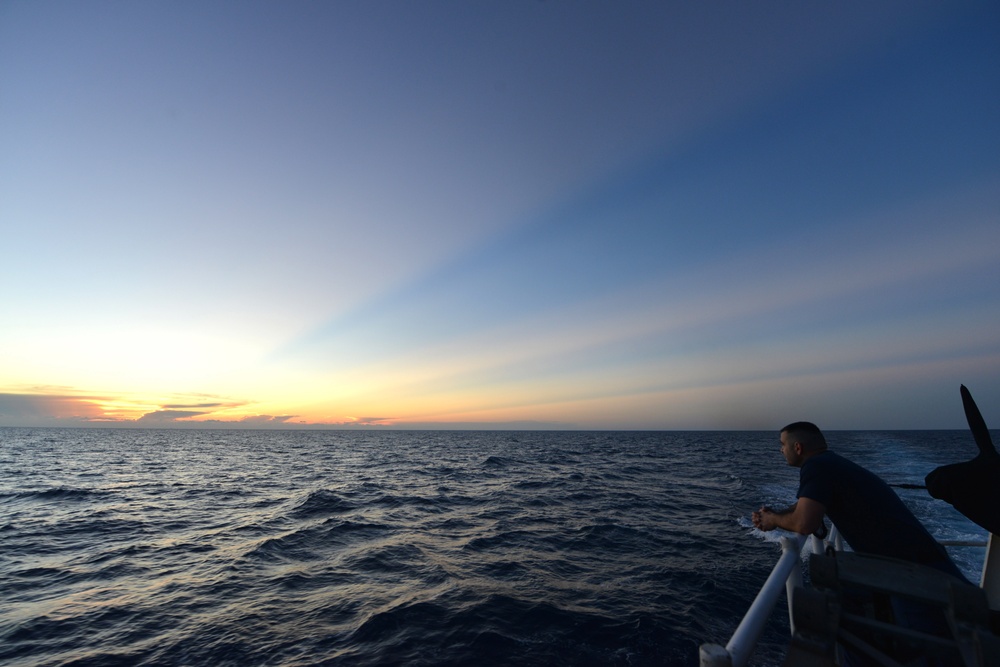 Bertholf sails under a night sky in the South China Sea