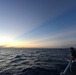 Bertholf sails under a night sky in the South China Sea