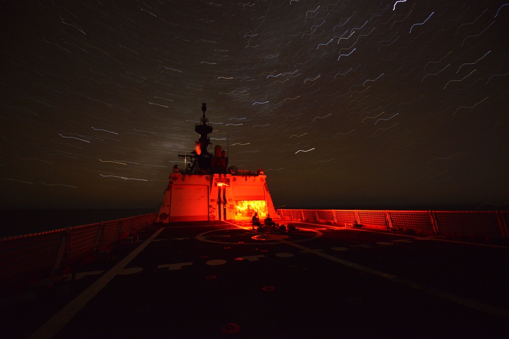 Bertholf sails under a night sky in the South China Sea