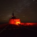 Bertholf sails under a night sky in the South China Sea