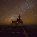 Bertholf sails under a night sky in the South China Sea