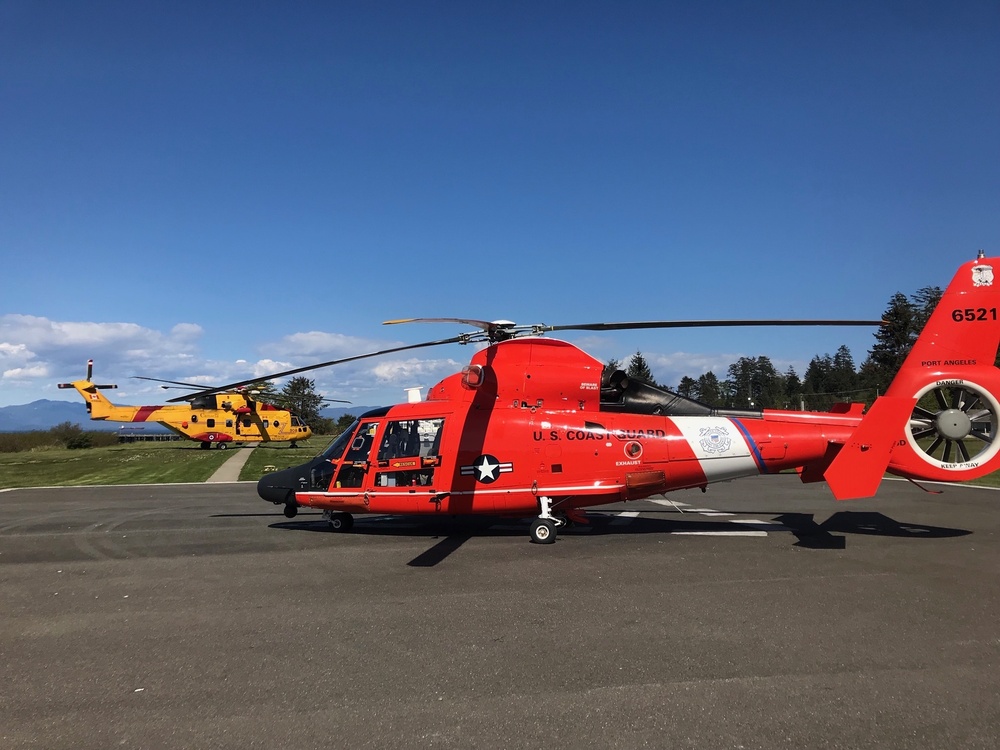 MH-65 dolphin aircrew transfers patients to Royal Canadian aircrew