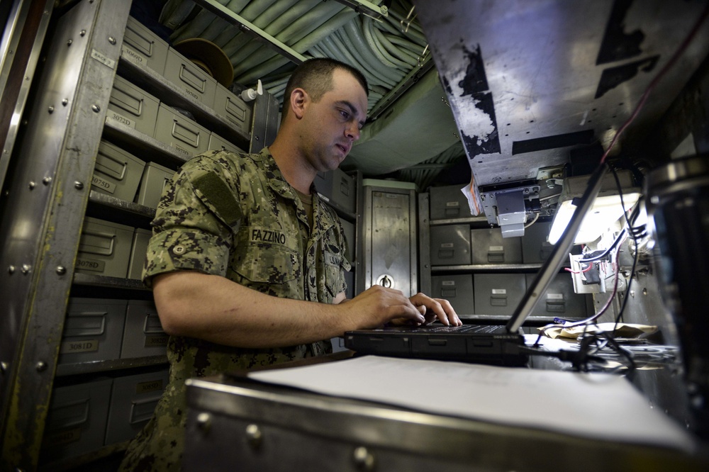USS Albany (SSN 753) Sailor Works in Supply Room