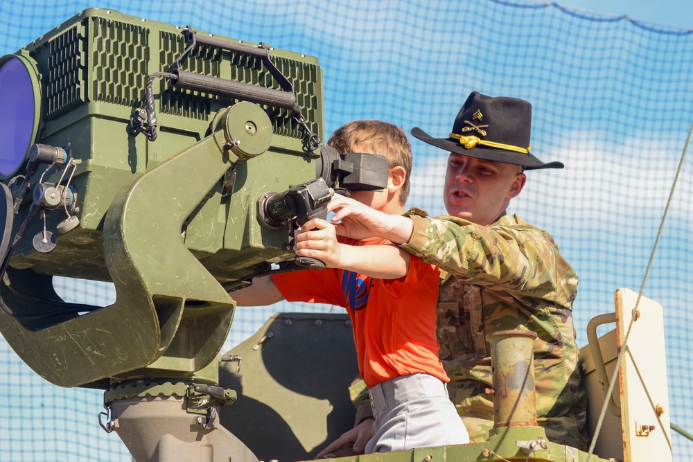 Soldiers raise flag at youth baseball game