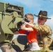 Soldiers raise flag at youth baseball game