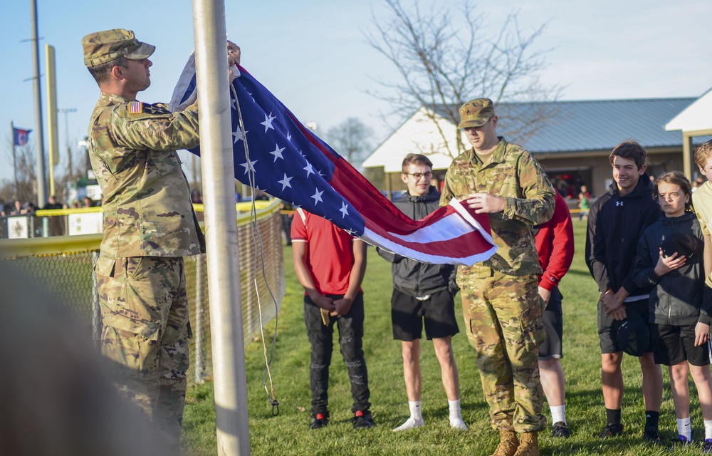 Soldiers raise flag at youth baseball game