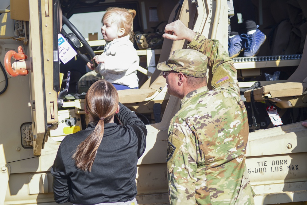 Soldiers raise flag at youth baseball game