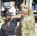 Soldiers raise flag at youth baseball game