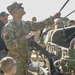 Soldiers raise flag at youth baseball game