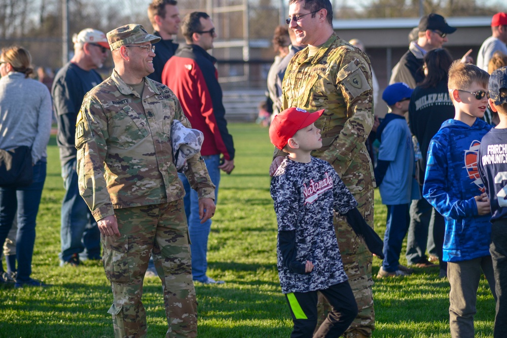 Soldiers raise flag at youth baseball game