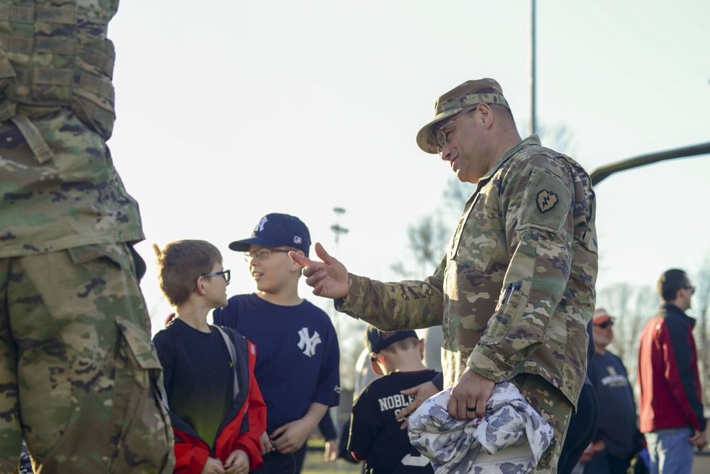 Soldiers raise flag at youth baseball game