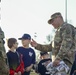 Soldiers raise flag at youth baseball game