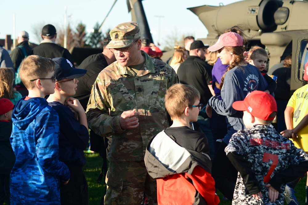 Soldiers raise flag for youth baseball game