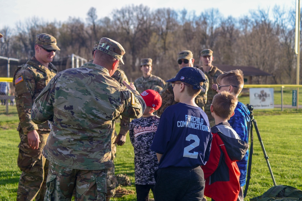 Soldiers raise flag for youth baseball game