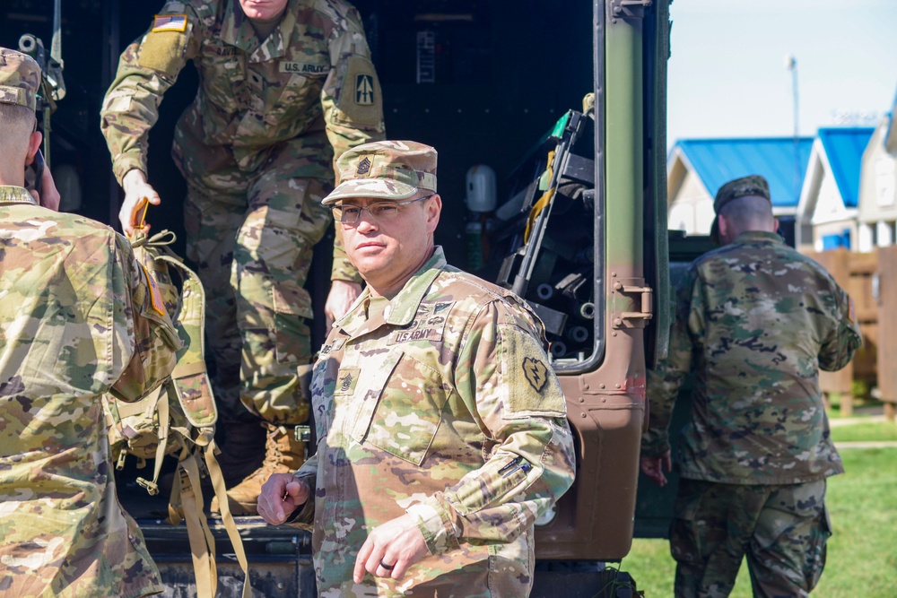 Soldiers raise flag for youth baseball game