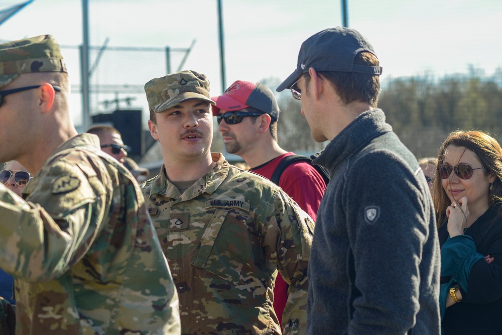 Soldiers raise flag at youth baseball game