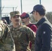 Soldiers raise flag at youth baseball game