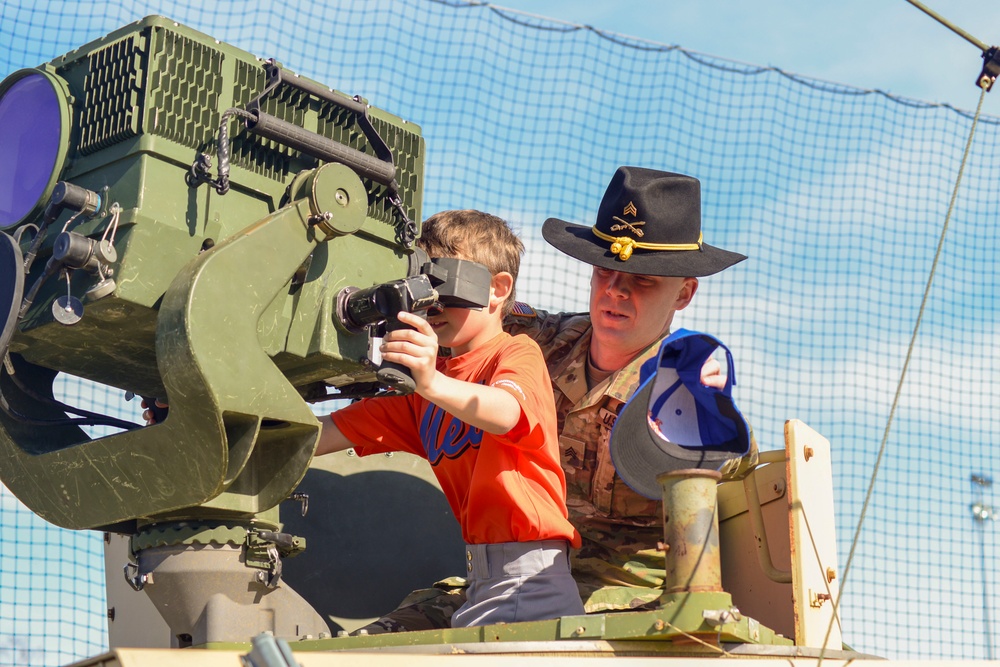Soldiers raise flag at youth baseball game