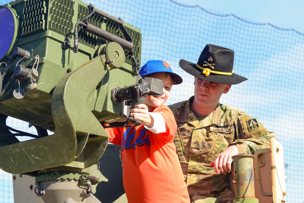 Soldiers raise flag at youth baseball game