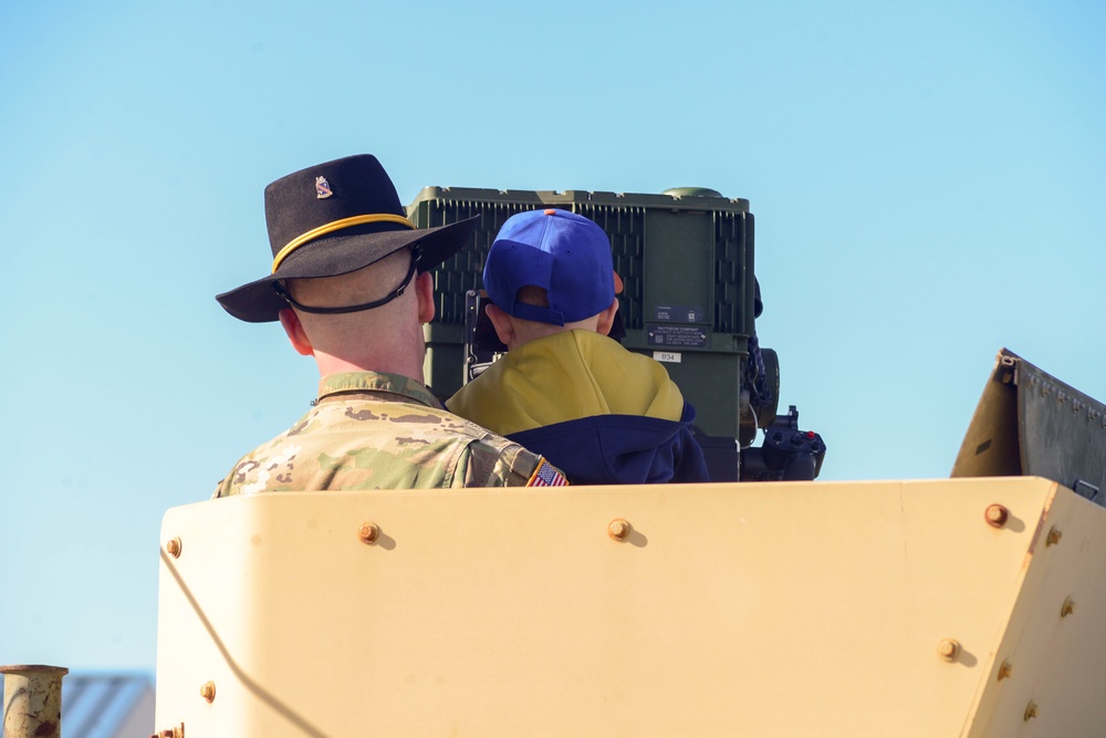 Soldiers raise flag at youth baseball game