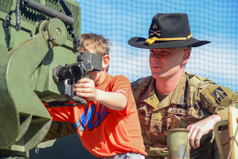 Soldiers raise flag at youth baseball game