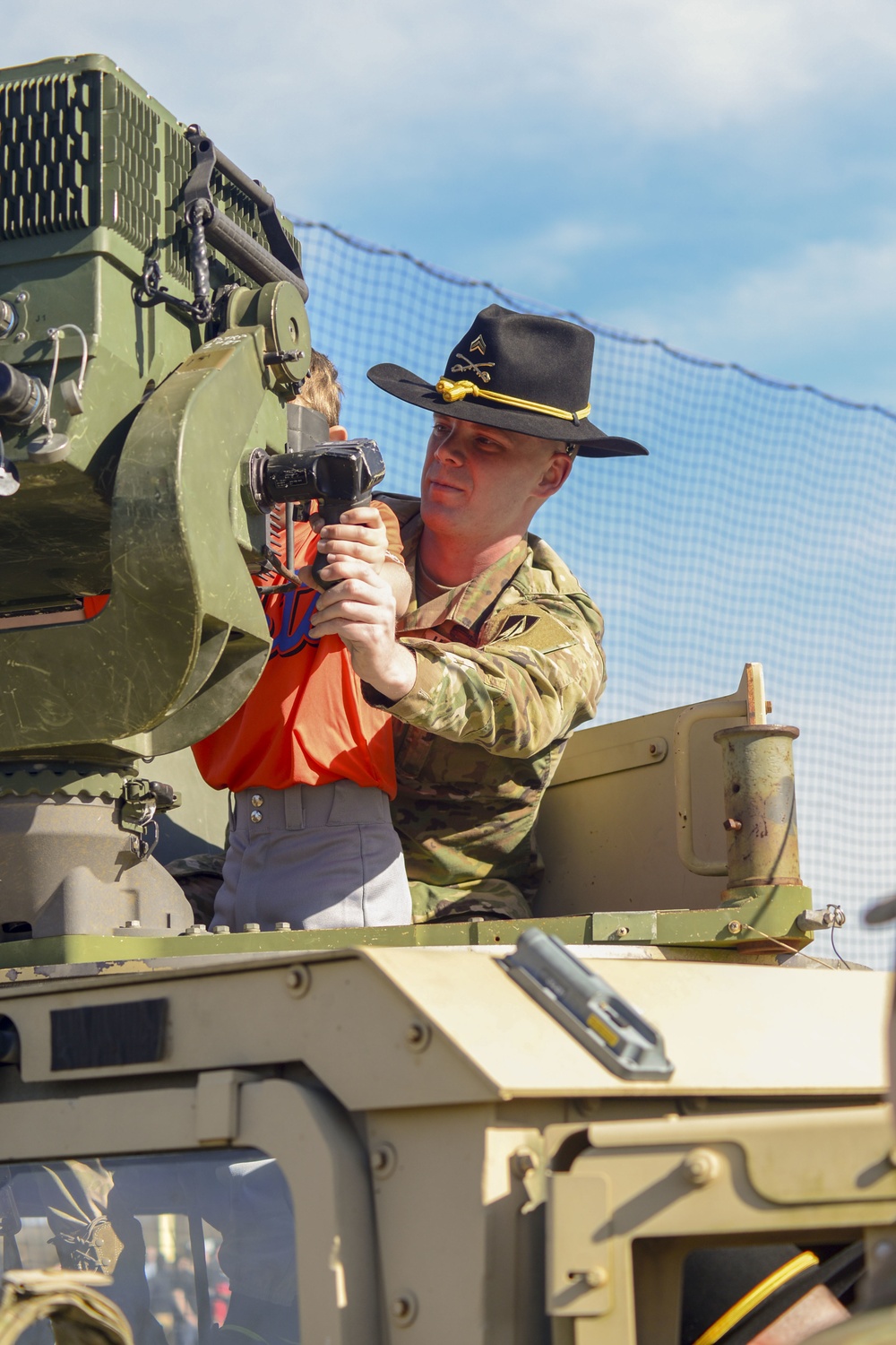 Soldiers raise flag at youth baseball game