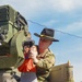 Soldiers raise flag at youth baseball game