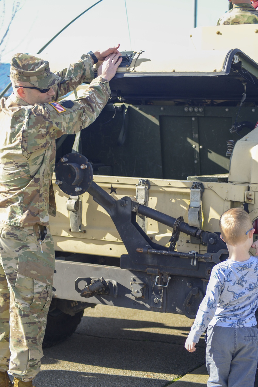 Soldiers raise flag at youth baseball game