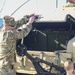 Soldiers raise flag at youth baseball game