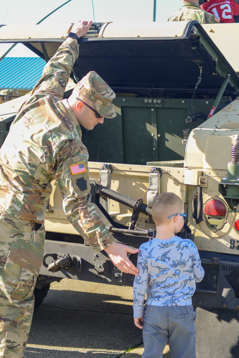 Soldiers raise flag at youth baseball game
