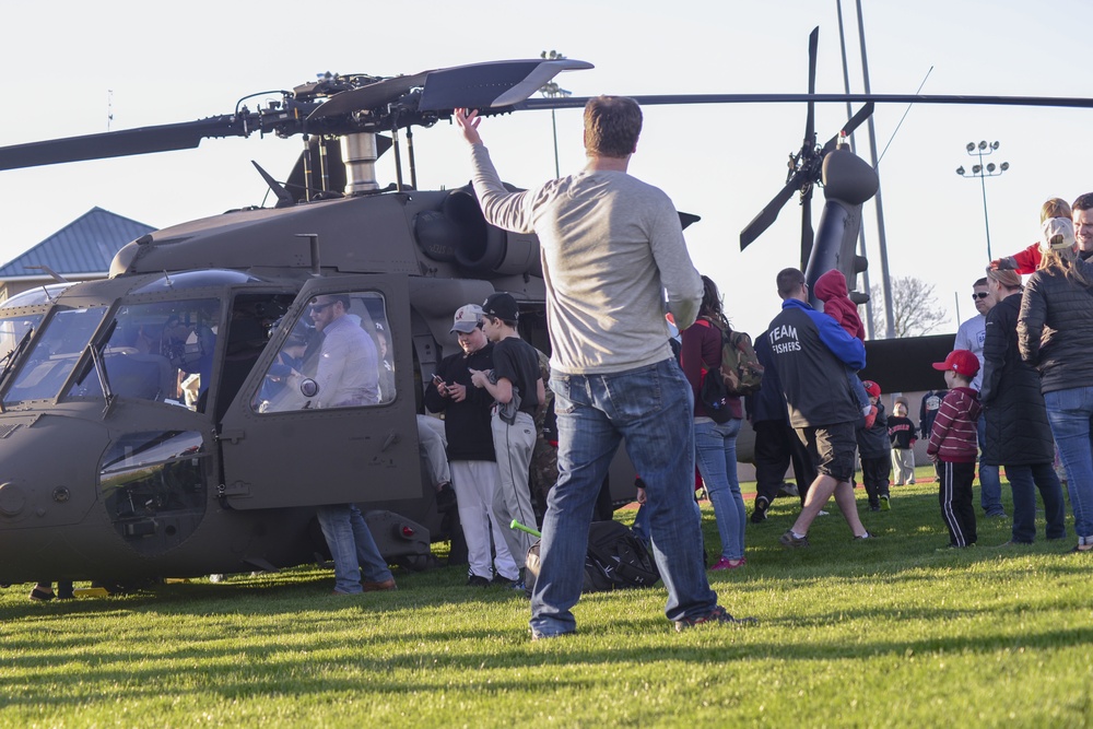 Soldiers raise flag at youth baseball game