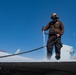 U.S. Sailors clean an F/A-18E Super Hornet