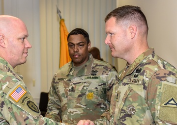 Col. Timothy Davis badges Sgt. 1st Class Dean Butcher with Basic Army Instructor Badge