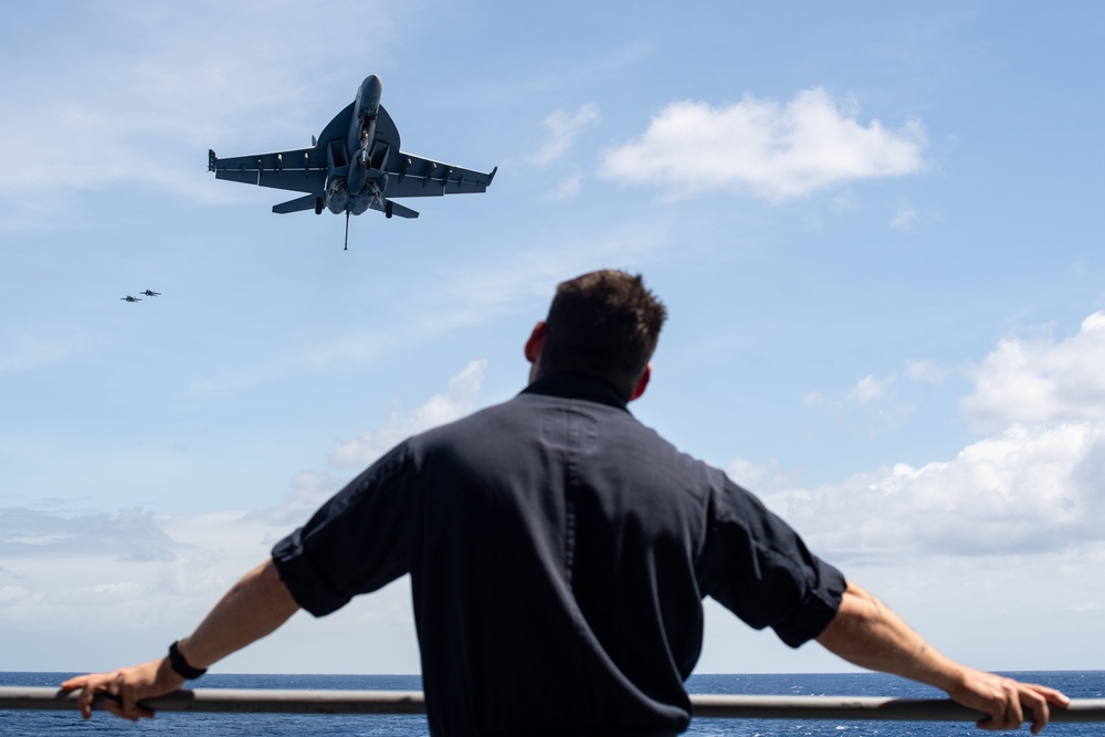 U.S. Sailor observes flight operations