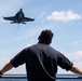 U.S. Sailor observes flight operations