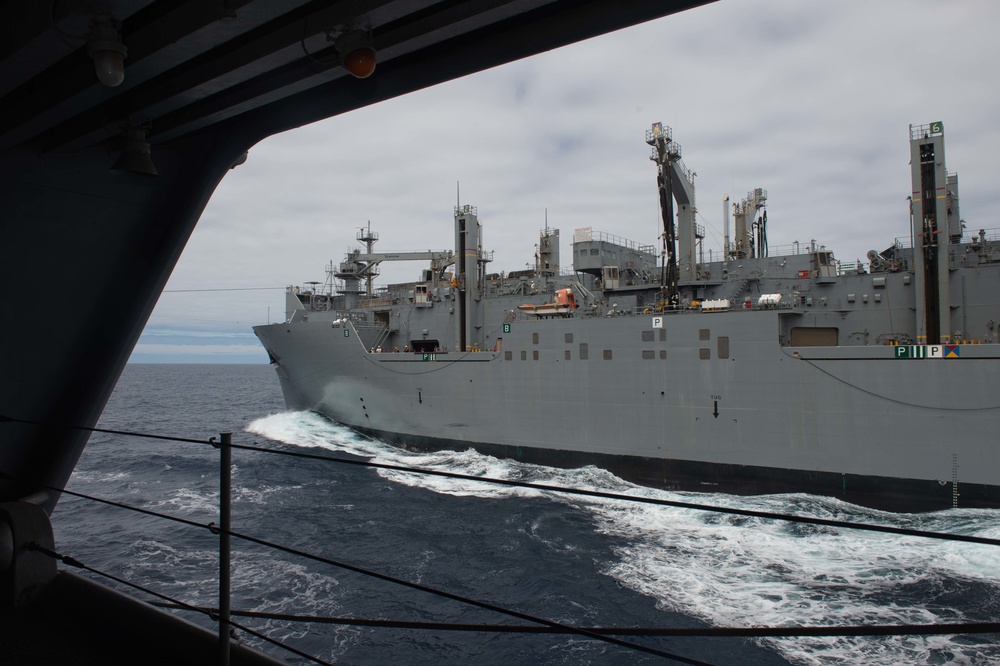 The dry cargo and ammunitions ship USNS Charles Drew (T-AKE 10) conduct a replenishment-at-sea alongside the aircraft carrier USS John C. Stennis (CVN 74)