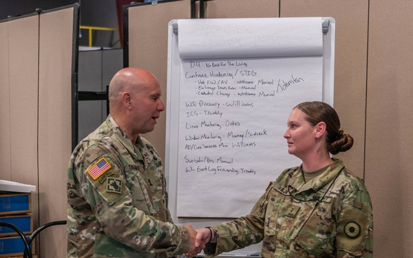 Maj. Gen. Lee Tafanelli congratulates Kansas Soldier