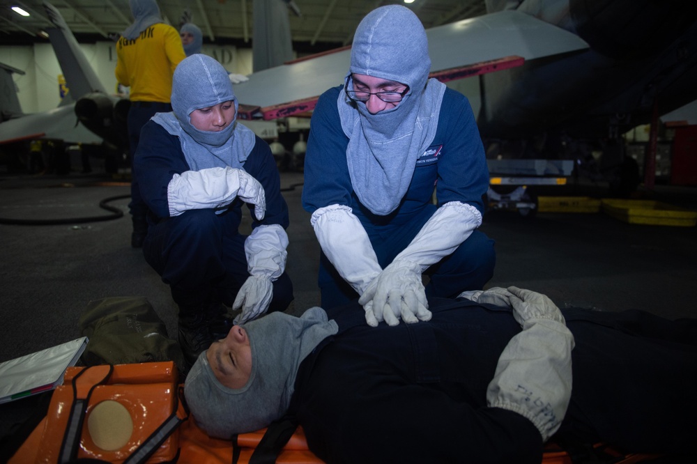 U.S. Sailors participate in a simulated general quarter drill