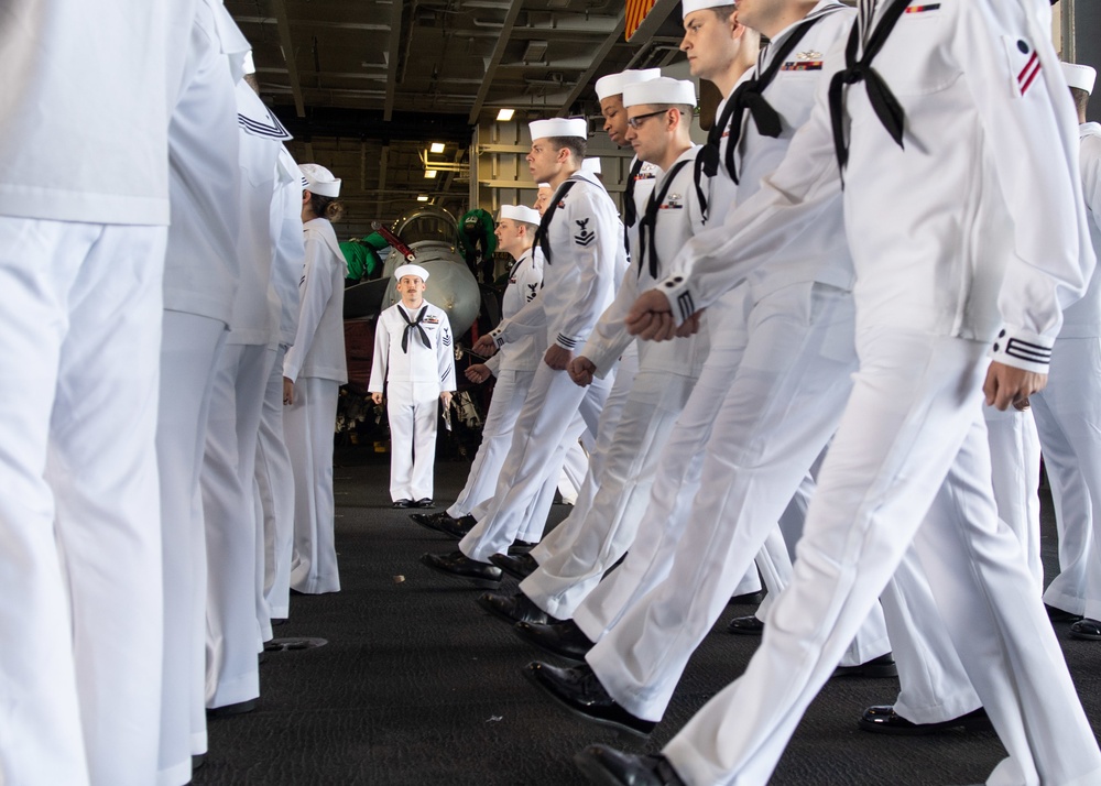 U.S. Sailors conduct a dress-white uniform inspection