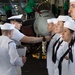 U.S. Sailors conduct a dress-white uniform inspection