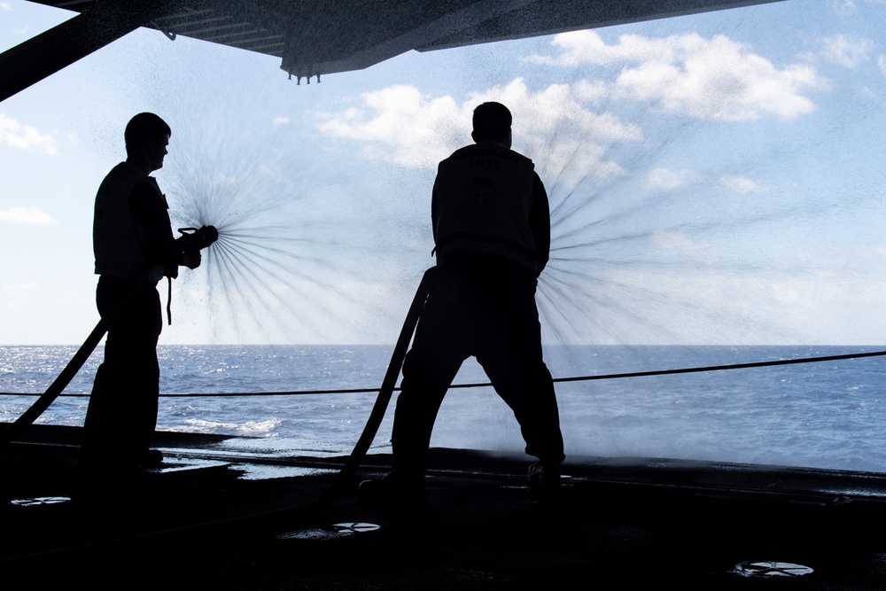 U.S. Sailors discharge firehoses