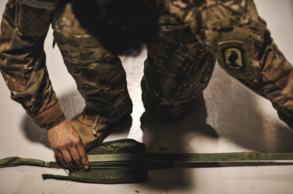 Paratrooper readies equipment