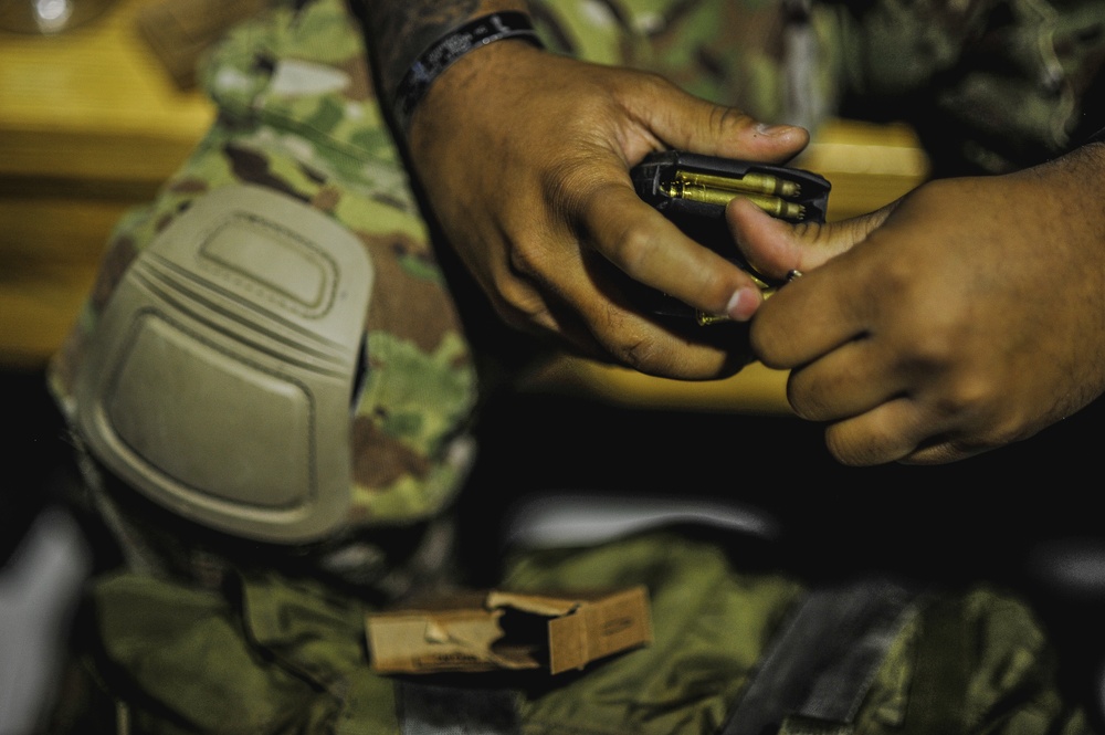 Paratrooper loads ammunition