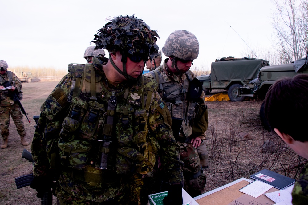 Canadian and U.S. Soldiers get briefed on an upcoming mission