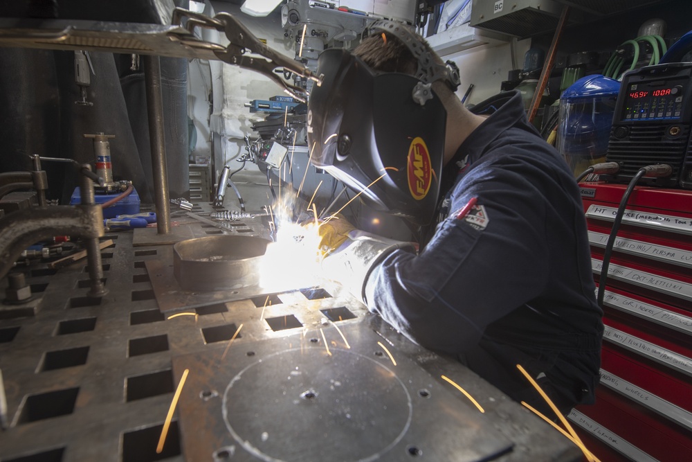 Hull Maintenance Technician 2nd Class Paul Boysen welds a fan bracket aboard the Arleigh Burke-class guided-missile destroyer USS Momsen (DDG 92).