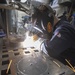 Hull Maintenance Technician 2nd Class Paul Boysen welds a fan bracket aboard the Arleigh Burke-class guided-missile destroyer USS Momsen (DDG 92).