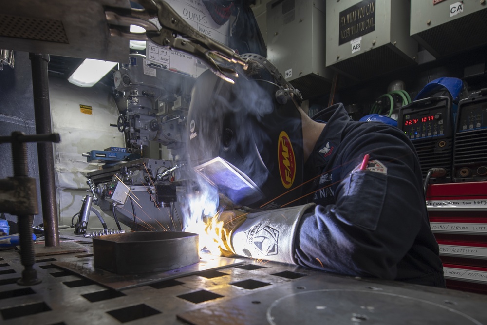 Hull Maintenance Technician 2nd Class Paul Boysen welds a fan bracket aboard the Arleigh Burke-class guided-missile destroyer USS Momsen (DDG 92).