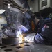 Hull Maintenance Technician 2nd Class Paul Boysen welds a fan bracket aboard the Arleigh Burke-class guided-missile destroyer USS Momsen (DDG 92).