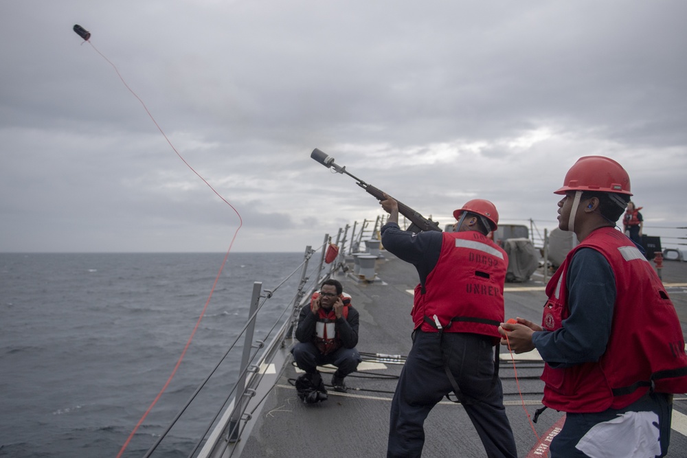 Gunner’s Mate Seaman Donovon Davis, center, fires a shot line during a replenishment-at-sea with the fleet replenishment oiler USNS Walter S. Diehl (T-AO 193) aboard the Arleigh Burke-class guided-missile destroyer USS Momsen (DDG 92).